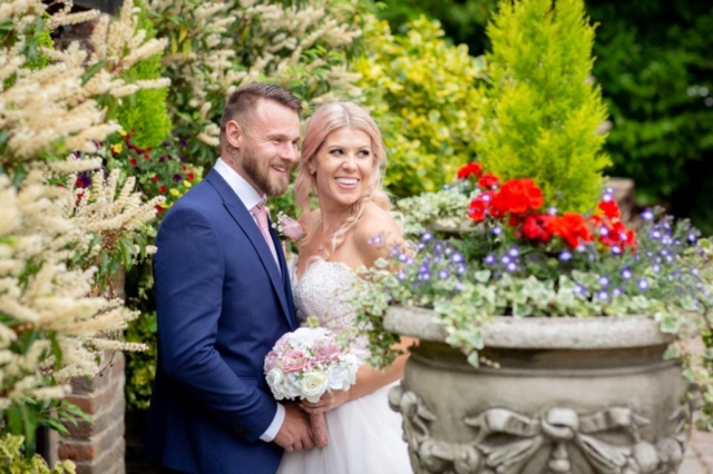 Bride and Groom Blue suit colorful flowers and leaves wedding venue essex