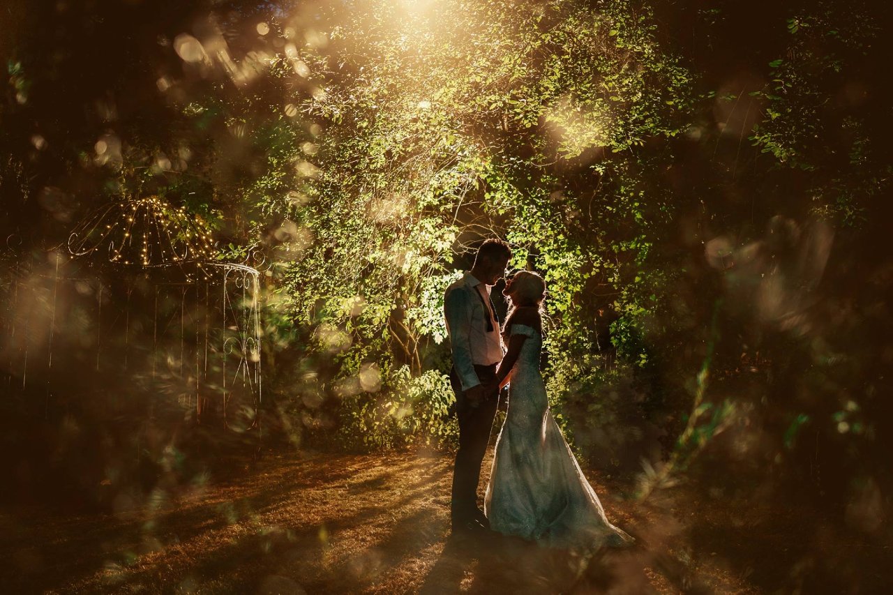 bride and groom hidden in trees
