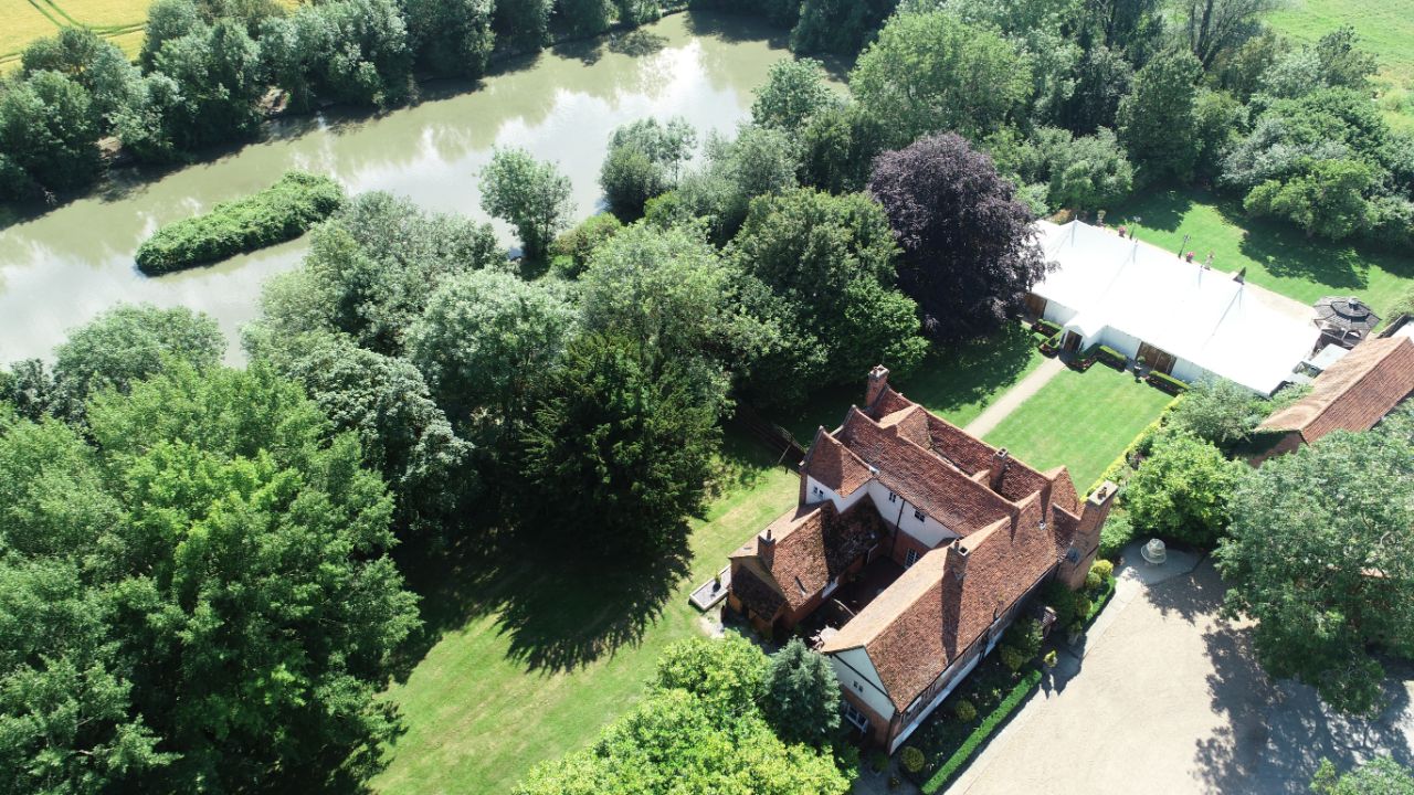Drone view of Newland Hall marquee and river wedding venue essex