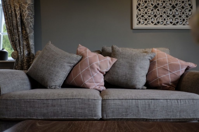 Grey and Pale Pink Sofa in Room