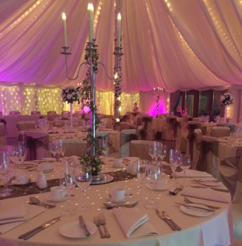 Pink and cream lighting inside Marquee at Newland Hall: wedding venue essex