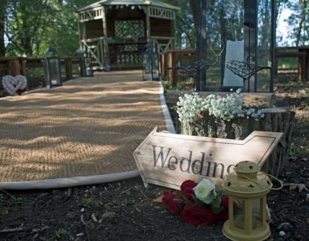 Wooden arrow reading "Wedding" pointing to gazebo