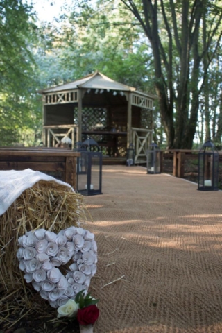 Flower Heart stood against Hay Bale on Wedding Isle in Woods