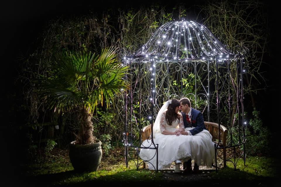 Metal Bench frame cover with fairy lights bride and groom wedding venue essex