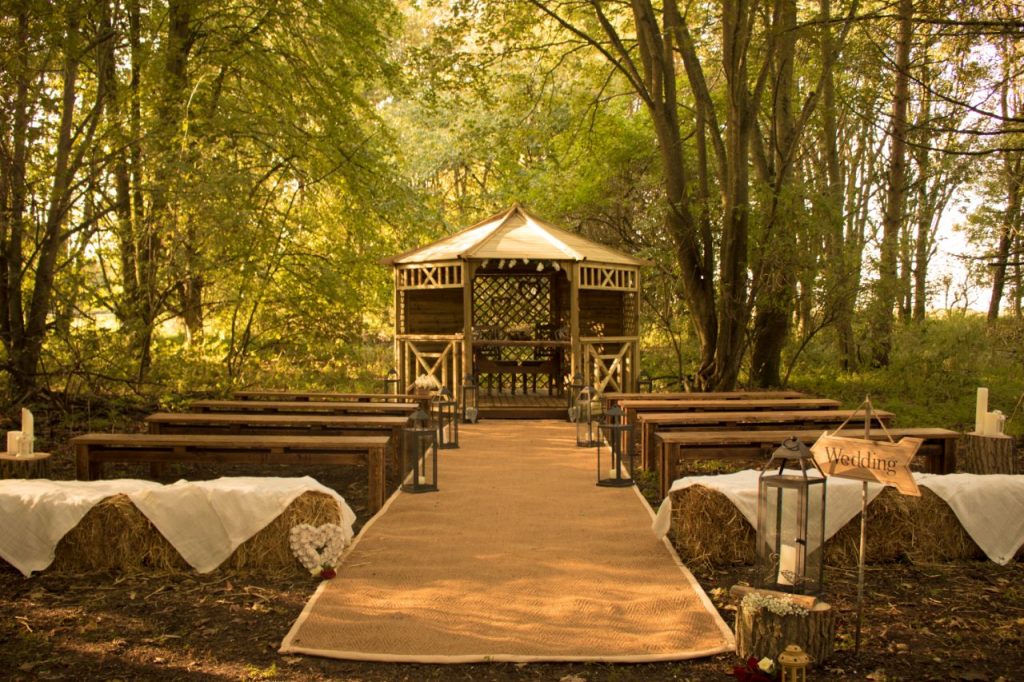 Tree covered wedding ceremony area wood theme