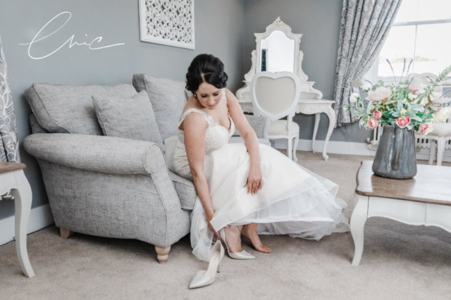 Bride putting on heels at Newland Hall