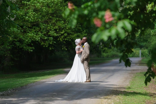 Newly Wed couple on tree covered path