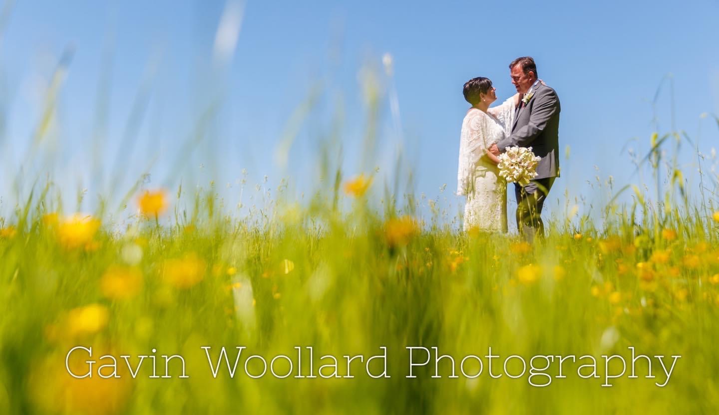 Newlyweds in a flower field at Newland Hall